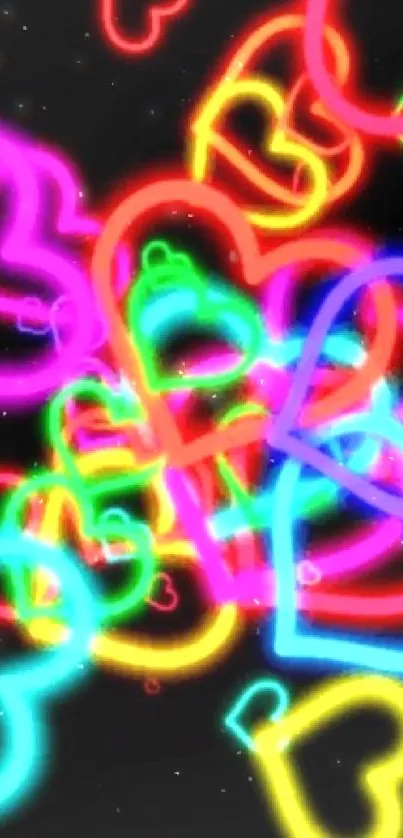 Neon hearts in vibrant colors on black background.