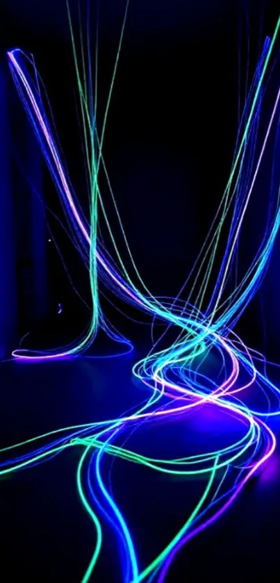 Neon light trails in blue, green, and purple on a dark background.