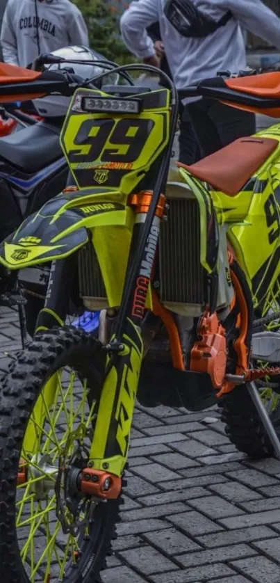 Neon yellow motocross bike parked outdoors.