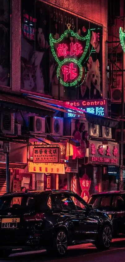 Vibrant neon-lit city street at night with cars and shops.