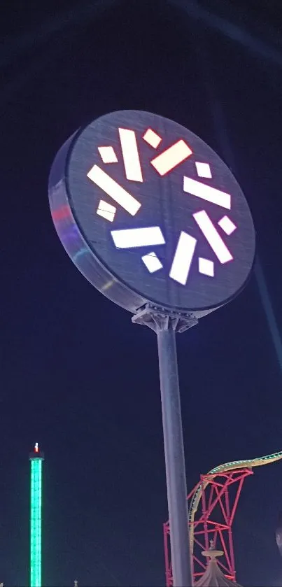 Neon signs against a dark night sky with vibrant amusement park elements.