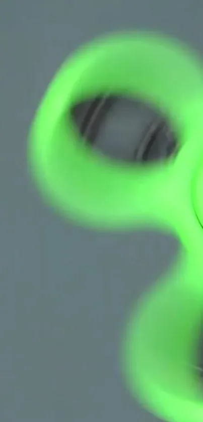 Neon green fidget spinner on a smooth background.