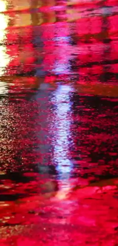 Vibrant neon street reflection with bright red and pink hues on wet pavement.