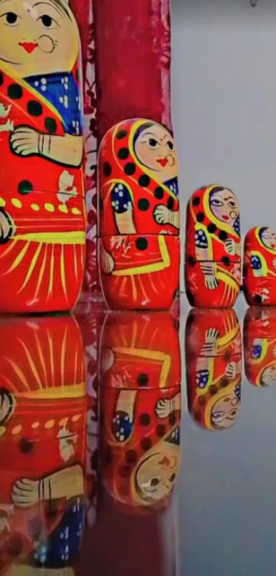 Colorful nesting dolls with reflections on a shiny surface.