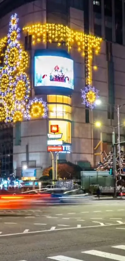 Vibrant night cityscape with illuminated buildings and festive lights.