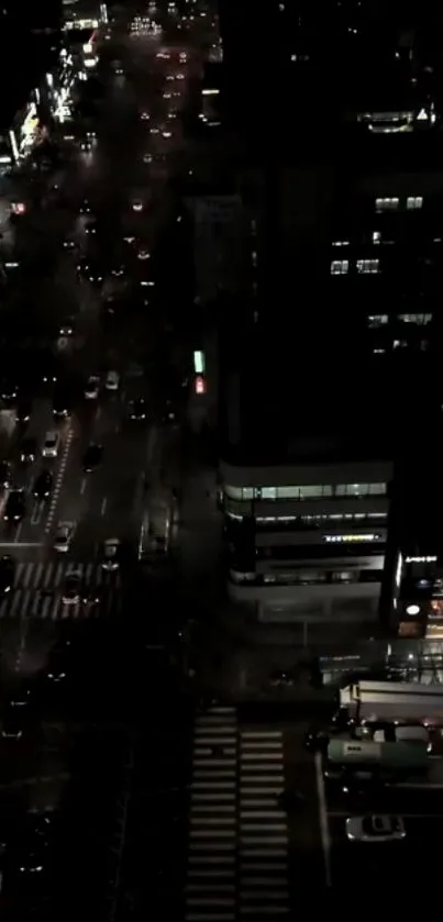 Aerial view of bustling city streets illuminated at night.