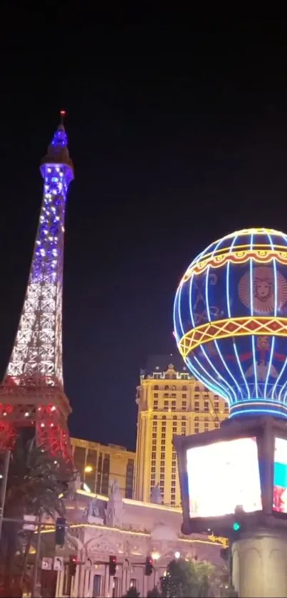 Vibrant night view of illuminated Eiffel-style tower and neon globe in cityscape.