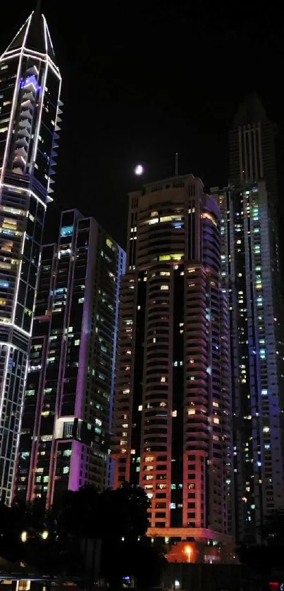 Illuminated skyscrapers at night in vibrant cityscape.