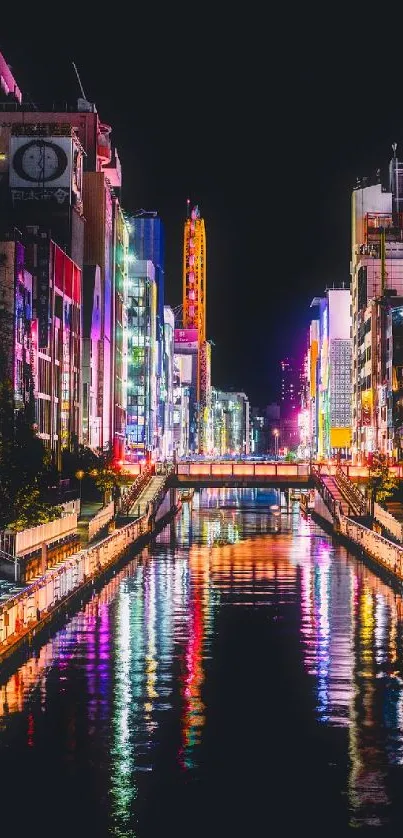 Colorful cityscape at night reflecting on water.