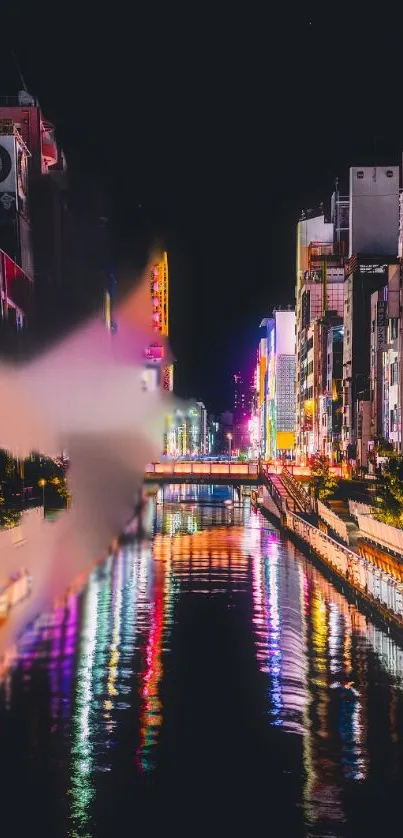 Vibrant night cityscape with colorful river reflections.