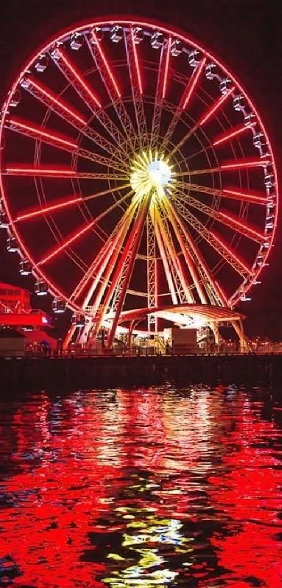 Neon-lit Ferris wheel reflecting on water at night.