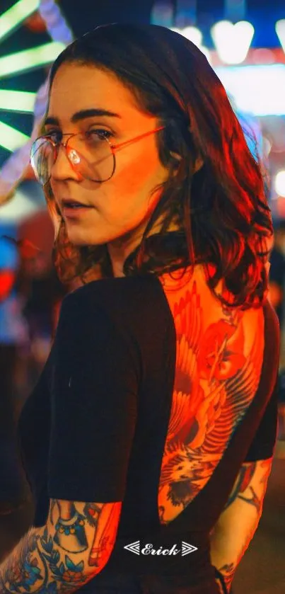 Woman at a vibrant festival with tattoos and bright lights.