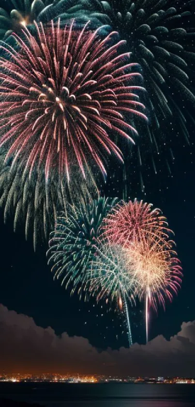 Vibrant fireworks lighting up a dark blue night sky over a calm body of water.