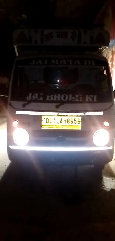 Van illuminated by streetlights at night on a city road.