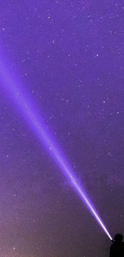 Violet beam piercing through a starry night sky wallpaper.