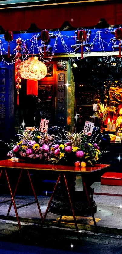 Vibrant temple at night with colorful lights and offerings against a dark backdrop.