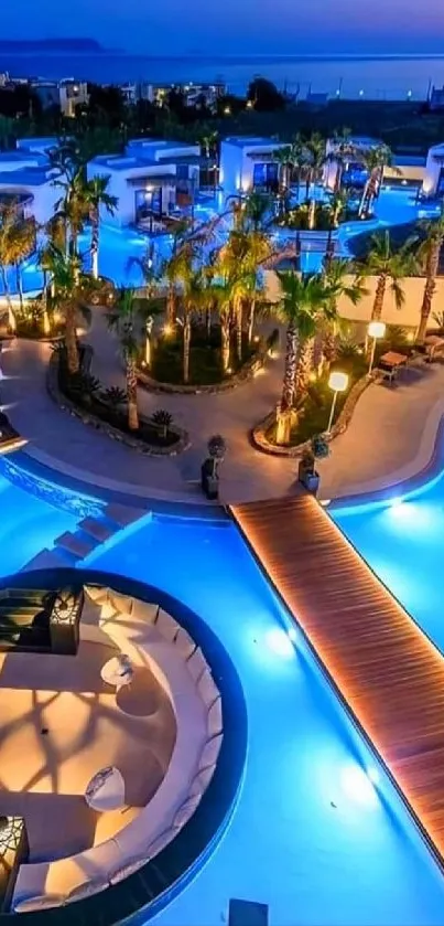 Nighttime view of a vibrant blue-lit resort pool with seating.