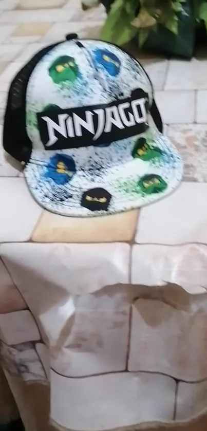 Ninjago-themed cap on rustic table for wallpaper.