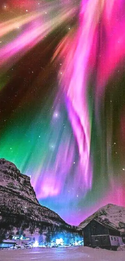 Vibrant aurora borealis over snow-capped mountains at night.