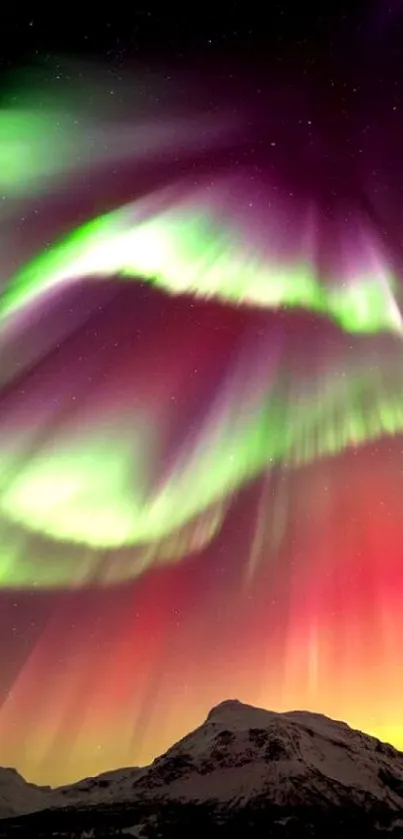 Colorful Northern Lights over snowy mountains.