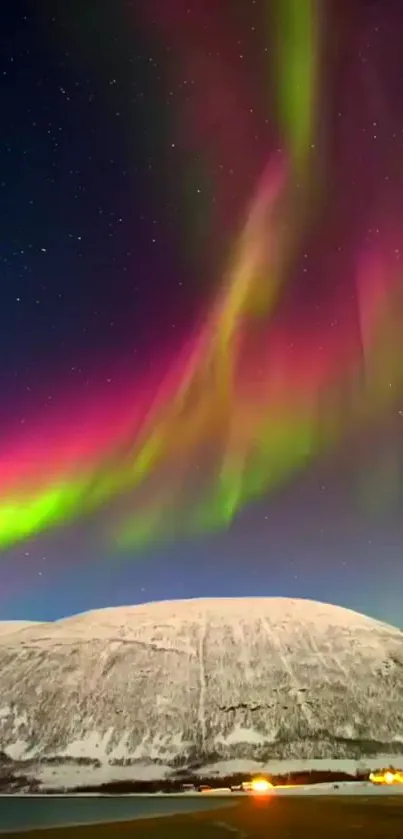 Colorful northern lights over snow-covered mountain.