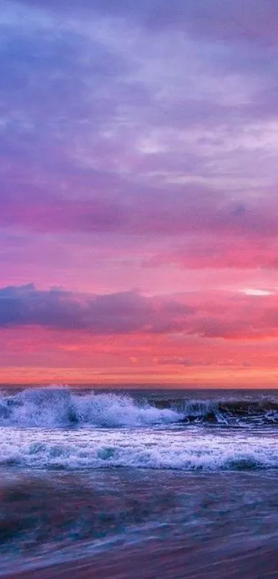 Vibrant sunset over ocean with pink and purple skies.