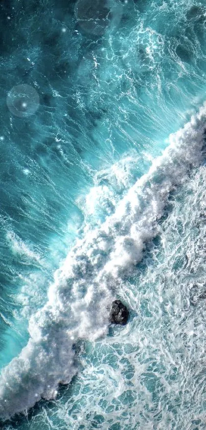 Dynamic ocean wave crashing on rocky shore in turquoise shades.