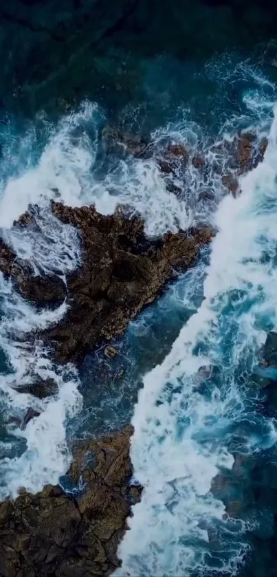 Aerial view of ocean waves crashing over rocky formations.