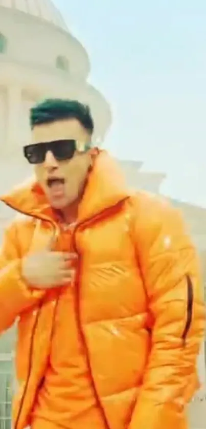 Man wearing a vibrant orange jacket in a stylish urban setting.