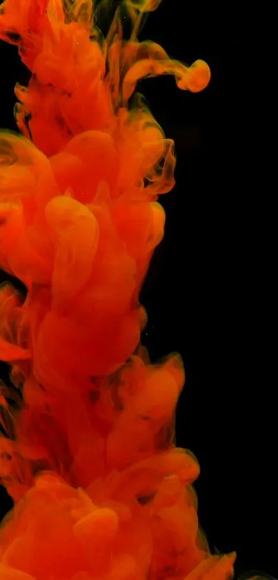 Vibrant orange ink swirling on black background.