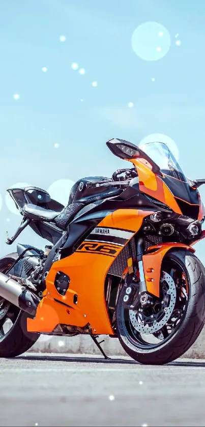 Vibrant orange sport motorcycle parked on an open road.