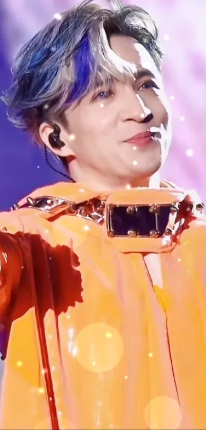 Performer in vibrant orange costume with a purple stage background.