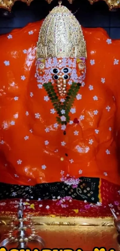 Vibrant orange religious idol with intricate details and cultural essence.