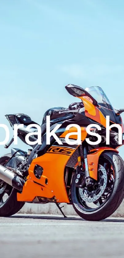 Orange sportbike on a road against blue sky backdrop.