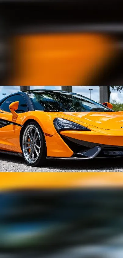 Orange sports car parked elegantly on a road under blue skies.