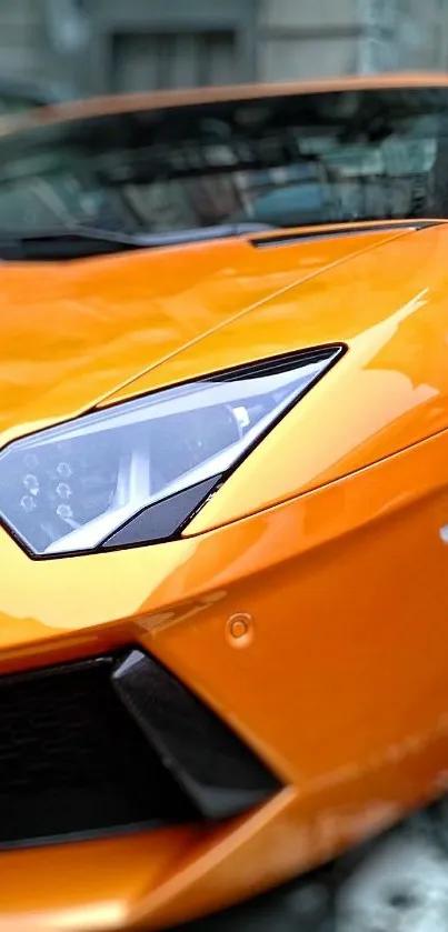 Close-up of a vibrant orange sports car, showcasing sleek design and style.