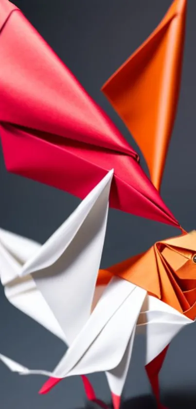 Vibrant origami bird with red and orange wings in artistic design.