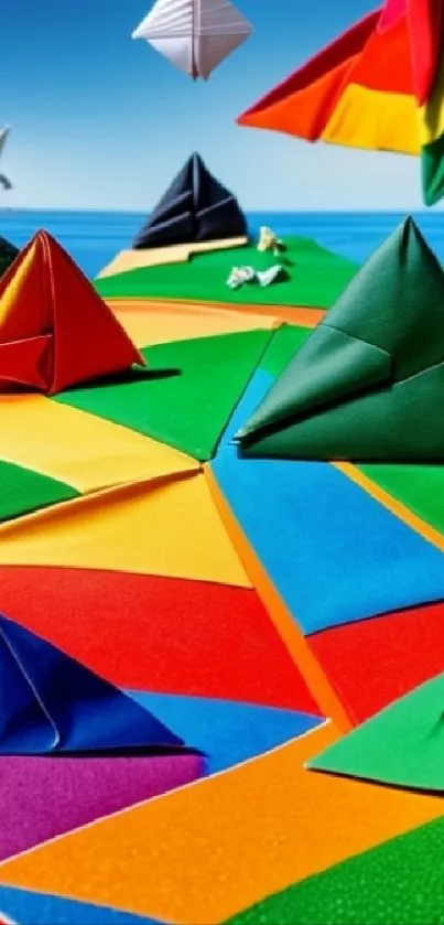 Colorful origami paper pyramids against a blue sky in a vibrant landscape wallpaper.