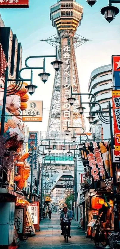 Osaka street view with Tsutenkaku Tower, vibrant signage, and cultural atmosphere.