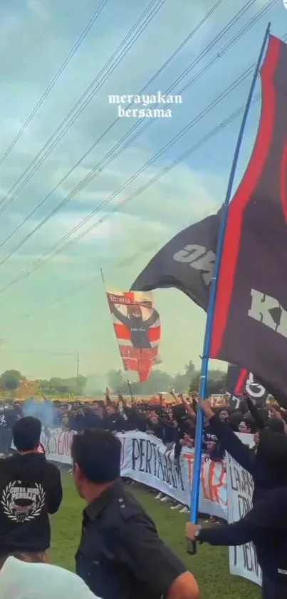 Outdoor celebration with vibrant flags and lively crowd.