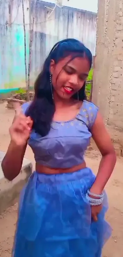 Girl dancing outdoors in blue dress