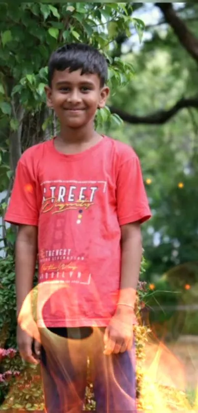 Smiling boy in red shirt with fiery effect against green background.