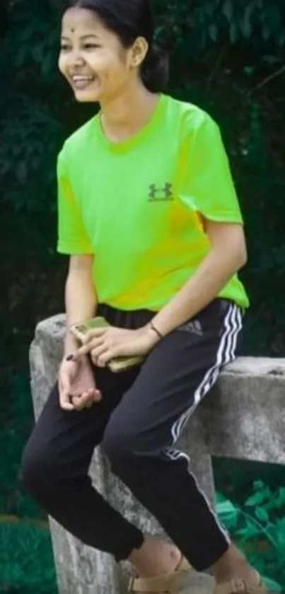 Young person in bright green shirt outdoors.