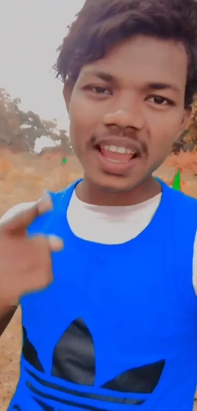 Young person in blue vest outdoors with vibrant background.