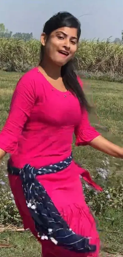 Person in bright pink attire in natural setting