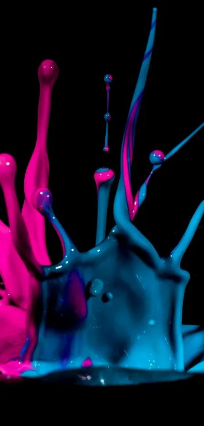 Vibrant pink and blue paint splash on black background.