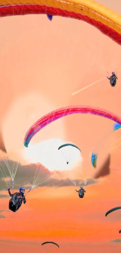 Paragliders soaring during vibrant sunset.