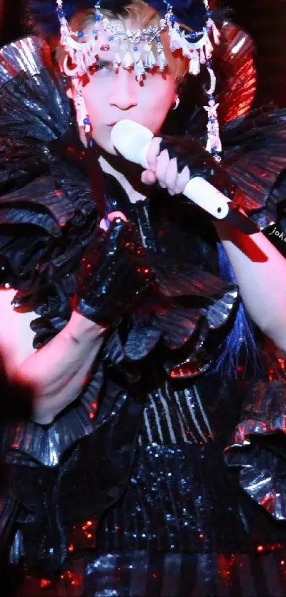 Artistic performer in elaborate red and black costume on stage.