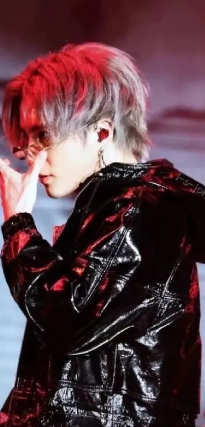 Stylish performer with red hair and glossy black jacket on stage.