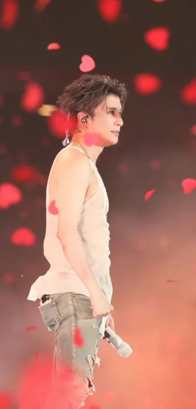 Energetic performer on stage with red heart confetti.